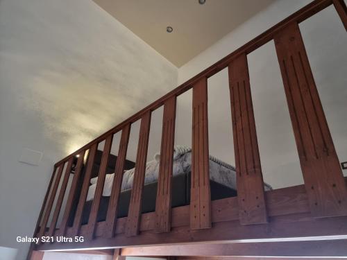 a wooden staircase with a bed in a room at San Ciro's Suite in Portici