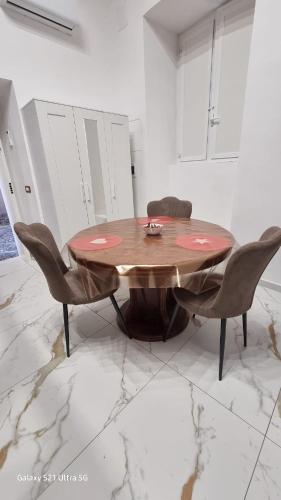 a wooden table and chairs in a room at San Ciro's Suite in Portici