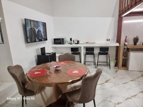 a dining room with a wooden table and chairs at San Ciro's Suite in Portici