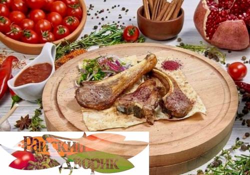 a table topped with a plate of meat and tomatoes at Райский Дворик in Pogreby