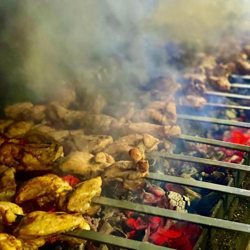 a bunch of animals cooking on a grill at Райский Дворик in Pogreby