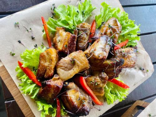 a plate of food with meat and vegetables on a table at Райский Дворик in Pogreby