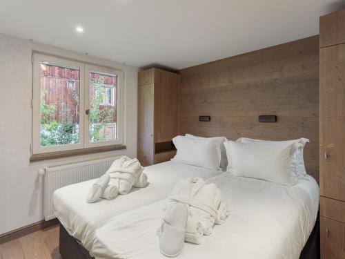 a bedroom with two beds with white sheets and a window at Duplex de Standing pour 6 Pers. au Centre de Courchevel, Près des Pistes - FR-1-564-36 in Courchevel