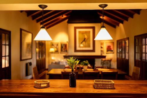 a wooden table with a vase of flowers on it at Estancia Iberá in Colonia Carlos Pellegrini