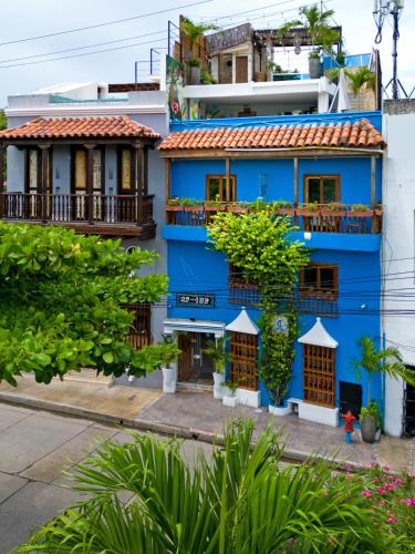 a blue building with balconies on a city street at Voilá Signature Casa Isabel in Cartagena de Indias