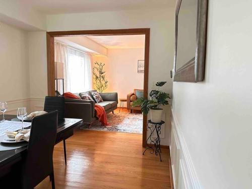 a living room with a table and a living room with a couch at Cozy 3 bdr Retreat in a Prime location in Streamwood