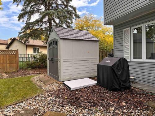 a shed with a mattress in front of a house at Cozy 3 bdr Retreat in a Prime location in Streamwood