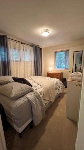 a bedroom with two beds and a window at Blue Heron Sanctuary & Serene, river-front cottage in West Linn