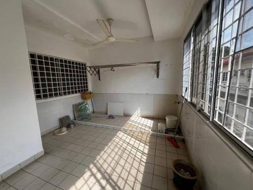an empty room with a tile floor and windows at Prime Villa in Kuala Lumpur