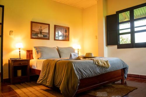 a bedroom with a bed with a laptop on it at Estancia Iberá in Colonia Carlos Pellegrini