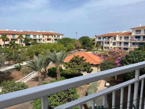 a balcony view of a resort with palm trees and buildings at Holiday Home - Santa Maria in Prainha