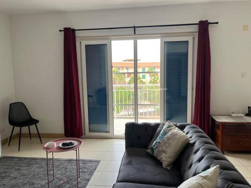 a living room with a couch and a sliding glass door at Holiday Home - Santa Maria in Prainha