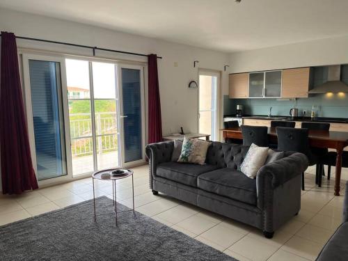 a living room with a couch and a kitchen at Holiday Home - Santa Maria in Prainha