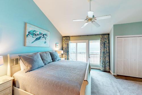 - une chambre avec un lit et un ventilateur de plafond dans l'établissement Ocean Mile G-3, à Île Saint Georges