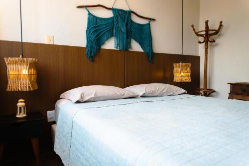 a bedroom with a large bed with blue comforter at Chalé Pipa Atlântico in Pipa