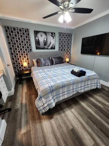 Blue Shark *G13* @ Midtown Central 1BR King Apartment في هيوستن: غرفة نوم بسرير وتلفزيون بشاشة مسطحة