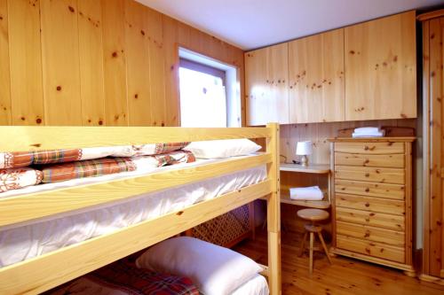 une chambre avec deux lits superposés et un bureau dans l'établissement CASA DOLOMIA - Cavalese Olimpiadi 2026, Dolomiti Affitti, à Cavalese