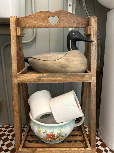 a wooden shelf with a bowl and a swan on it at Lakeside house in Oughterard