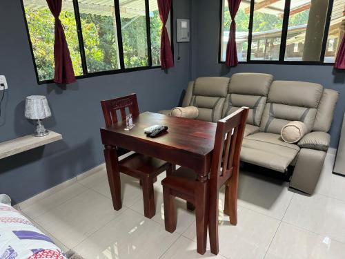 a living room with a table and a couch at El mangal B&B in Suchitoto