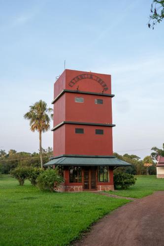 a red tower with a sign on top of it at Estancia Iberá in Colonia Carlos Pellegrini