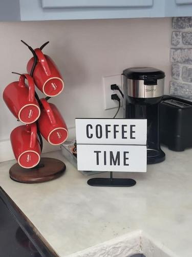 a coffee time sign on a kitchen counter with a coffee machine at 4Bedroom 3Bath Home Near Fort Jackson in Columbia
