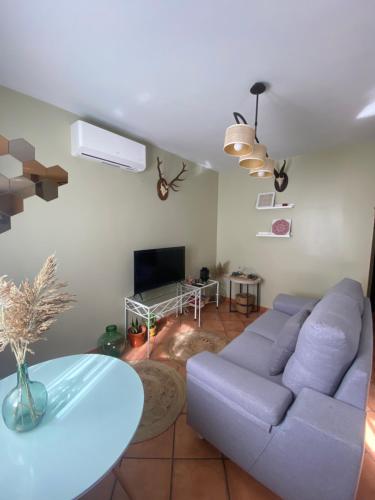 a living room with a blue couch and a table at Apartamentos La Palma in Ubrique