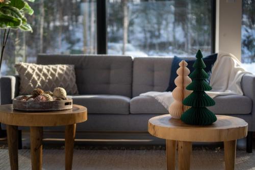 a living room with two tables with a christmas tree on them at Andas cabin CITQ#313550 in Lac-Superieur