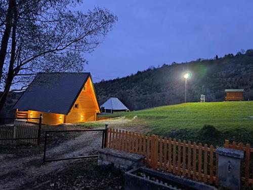 a wooden cabin on a hill with a street light at Vikendica i odmaraliste JuliE, Sarajevo-Jahorina in Tvrdimići