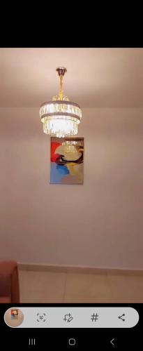 un lustre suspendu au plafond avec une photo dans l'établissement Triad apartments and Tsavo apartment, à Nairobi
