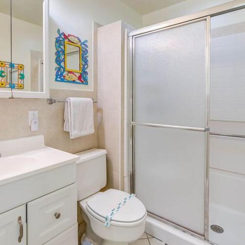 a bathroom with a toilet and a glass shower at Little Bay Prime in Islamorada