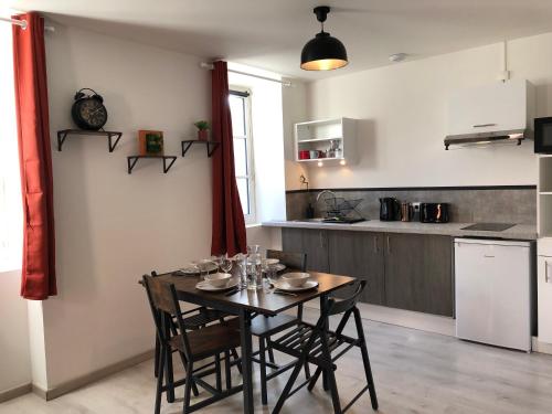 a kitchen and dining room with a table and chairs at Terre Montbrisonnaise in Montbrison