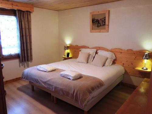 a bedroom with a bed with two pillows on it at Les Gets : Appt 10 pers skis aux pieds, balcon, parking, wifi - FR-1-598-72 in Les Gets