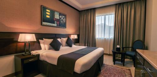 a hotel room with a large bed and a window at Afraa Hotel Al Aziziya in Mecca