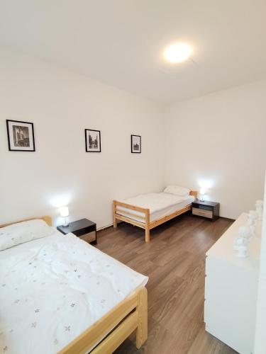 a room with two beds and two tables at Schwert City Loft S41 in Verden