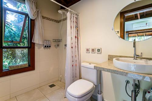 a bathroom with a toilet and a sink and a mirror at Ateliê aconchegante em meio à natureza ATL018 in Florianópolis