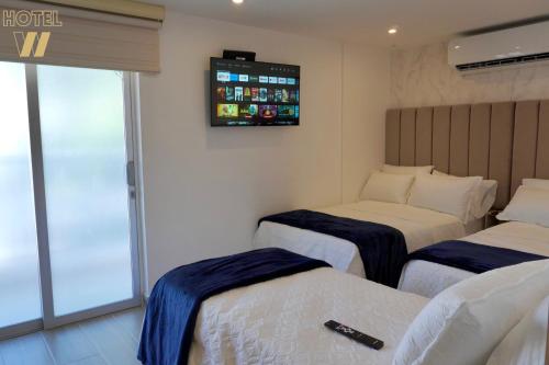 Una cama o camas en una habitación de HOTEL W Santa Marta
