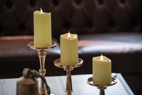 a group of three candles on a table at Christmas Farm Inn and Spa in Jackson