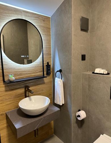 a bathroom with a sink and a mirror at Sana Ski apartment 702 in Flora, Borovets in Borovets