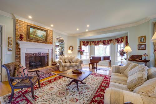 a living room with a couch and a fireplace at Immaculate Boone Villa with Entertainment Lounge! in Boone