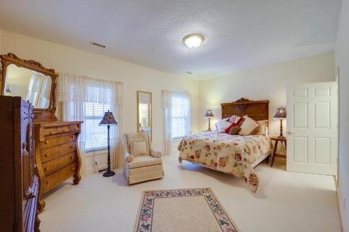 a bedroom with a bed and a dresser and a chair at Immaculate Boone Villa with Entertainment Lounge! in Boone