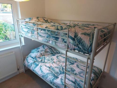 a bedroom with two bunk beds and a window at Spacious 3 bedroom house in lovely location in Birmingham