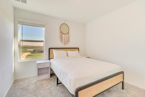 a white bedroom with a bed and a window at 12 Mi to Dtwn Austin Quiet Home with Patio and Yard in Austin