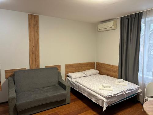 1 dormitorio pequeño con 1 cama y 1 silla en Modern Apartments Uzhgorod, en Uzhhorod