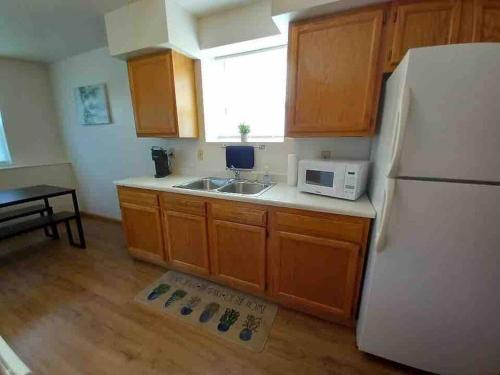 a kitchen with a white refrigerator and a sink at Ottawa’s Finest - Located Close to Downtown! in Ottawa