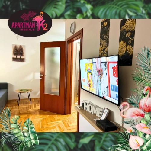 a living room with a tv and a door at Studio Apartman K2 in Trebinje