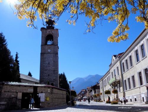a clock tower in the middle of a street at Deers in Bansko