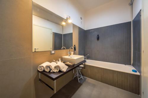 a bathroom with a sink and a bath tub at Santa Sofia Home in Milan