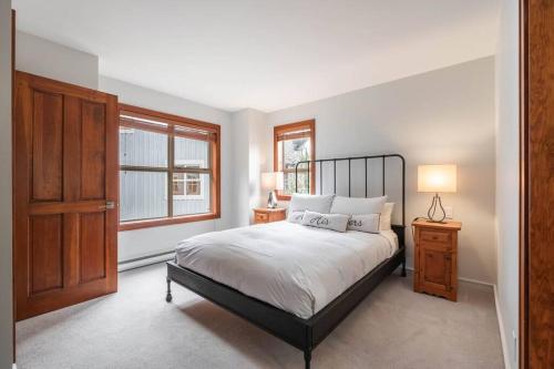 a bedroom with a large bed and a window at Treeline by Outpost Whistler in Whistler