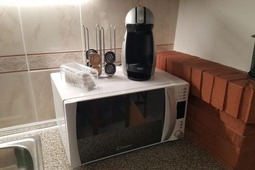 a coffeemaker sitting on top of a microwave at Cozy house, Bespén, Huesca 