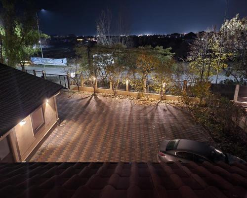 a car parked on a brick road at night at Adac Boutique Hotel in Bucharest